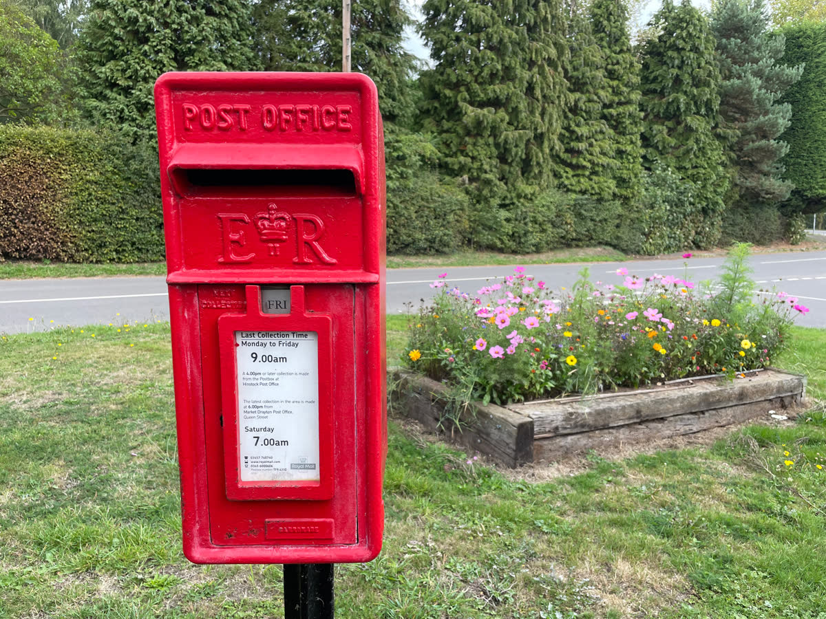 Village post box among hedges in Hinstock